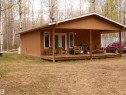 Welcome home!  Nestled in the trees is this 2 bedroom cabin/cottage. One level living--open concept kitchen/living space.  There is a half wrap porch/deck. Front one is covered and is West facing so you can enjoy the sunset skies! - 307 Willow Place, Rural Barrhead County, AB 