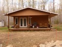 This view is more square-on & shows the garden door entryway. Front porch is covered so you can still sit outside if weather a bit inclement. Birds, deer and other wildlife abound in the area. Deer seem to have a "daily trek" through this area! - 307 Willow Place, Rural Barrhead County, AB 