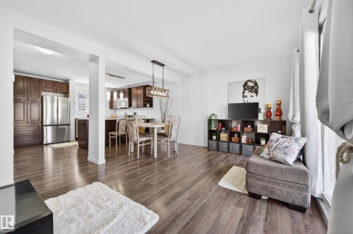 Spacious living area featuring wood-finish flooring, white walls, and bright natural light - 14522 56 Street, Edmonton, AB - Indoor Photo Showing Living Room