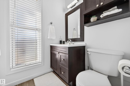 Bathroom featuring a dark wood-finish vanity with a white countertop and integrated sink - 14522 56 Street, Edmonton, AB - Indoor Photo Showing Bathroom