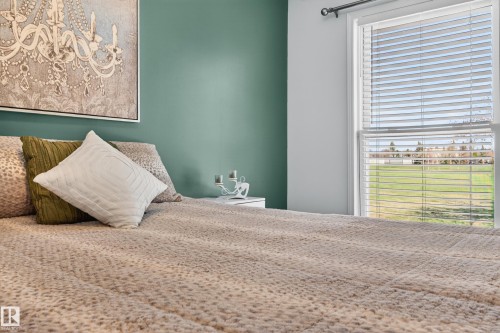 Spacious interior featuring a large window with white blinds overlooking a large park - 14522 56 Street, Edmonton, AB - Indoor Photo Showing Bedroom