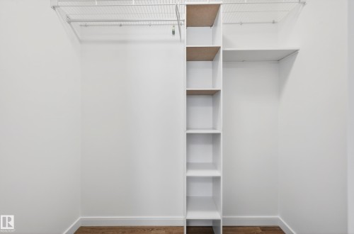 Customizable closet system featuring built-in shelving, wire racks, and hanging rods - 14522 56 Street, Edmonton, AB - Indoor With Storage