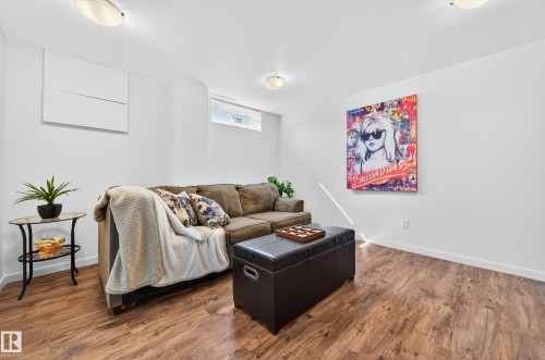 Spacious interior featuring wood-finish flooring, white walls, and bright lighting - 14522 56 Street, Edmonton, AB - Indoor