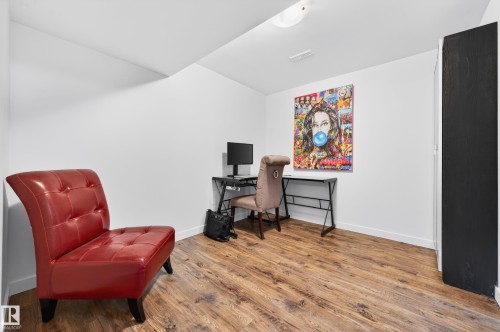 Dedicated room featuring wood-finish flooring, white baseboards, and bright white wall color - 14522 56 Street, Edmonton, AB - Indoor