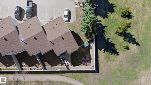Aerial perspective of the townhomes featuring brown shingled roofs and private fenced yards - 14522 56 Street, Edmonton, AB - Outdoor