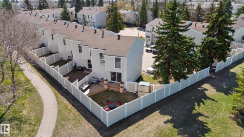 The property with a large private backyard featuring a wood deck and green space - 14522 56 Street, Edmonton, AB - Outdoor
