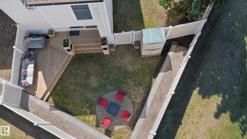 Expansive backyard featuring a multi-level wood deck with stairs, a dedicated fire pit area with a stone surround, and a shed - 14522 56 Street, Edmonton, AB - Outdoor