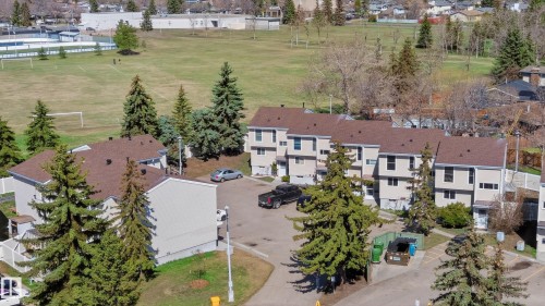 Front areal view of the townhome community featuring neutral siding and brown shingle roofing - 14522 56 Street, Edmonton, AB - Outdoor With View