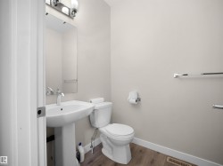 Pedestal sink with chrome fixtures and an overhead vanity light - 