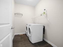 Dedicated laundry area featuring a front-loading washer and dryer set - 