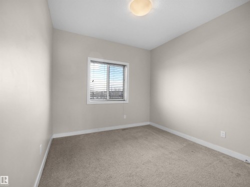 Neutral painted walls complementing light-toned carpet flooring - 8921 217 Street Nw, Edmonton, AB - Indoor Photo Showing Other Room