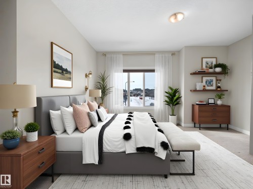 Bedroom featuring a large window with white trim, light-colored walls, and a textured ceiling - 8921 217 Street Nw, Edmonton, AB - Indoor Photo Showing Bedroom