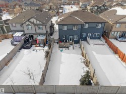 Two-story residence with a multi-level deck and fenced backyard - 