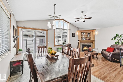 98 Hewitt Circle, Spruce Grove, AB - Indoor Photo Showing Dining Room With Fireplace