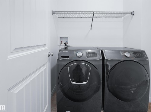 Dedicated laundry area with a wire shelving unit - 2017 32A Street, Edmonton, AB - Indoor Photo Showing Laundry Room