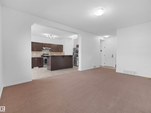 Spacious living area with carpet flooring - 2017 32A Street, Edmonton, AB - Indoor Photo Showing Kitchen