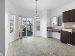Dining area featuring light-toned tile flooring and a bay window - 