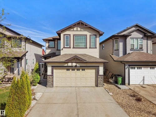 Two-story residence featuring light-colored siding and a two-car garage - 2017 32A Street, Edmonton, AB - Outdoor With Facade