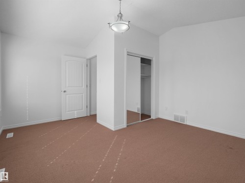 Spacious room featuring neutral white walls, brown carpeting, and white baseboards - 2017 32A Street, Edmonton, AB - Indoor Photo Showing Other Room