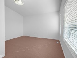 Room featuring broadloom carpeting, white baseboards, and neutral wall paint - 