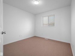Neutral-toned wall-to-wall carpeting complements the white walls and trim - 