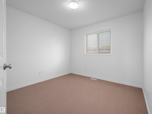 Neutral-toned wall-to-wall carpeting complements the white walls and trim - 2017 32A Street, Edmonton, AB - Indoor Photo Showing Other Room