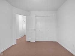 Neutral-toned carpeting and white walls define this interior space - 