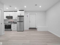 Open-concept living area featuring light wood-finish flooring - 