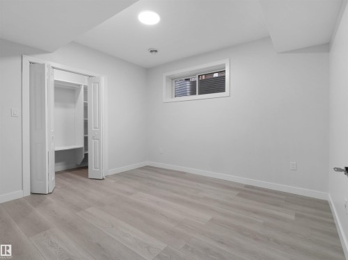 Room featuring light wood-finish flooring, white walls, and a recessed ceiling light - 2017 32A Street, Edmonton, AB - Indoor Photo Showing Other Room