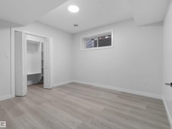 Room featuring light wood-finish flooring, white walls, and a recessed ceiling light - 