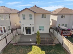 Rear exterior with a spacious multi-level deck featuring a dark composite finish - 