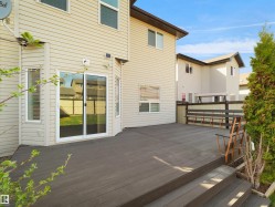 Spacious composite decking with dual-level design and dark wood-tone railing - 