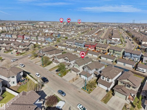 Residential neighborhood featuring detached and semi-detached homes with various exterior finishes and attached garages - 2017 32A Street, Edmonton, AB - Outdoor With View