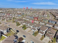 Residential neighborhood featuring detached and semi-detached homes with various exterior finishes and attached garages - 