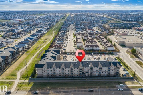 Multi-story residential building with light-colored siding and dark gable roofs - 412 5005 165 Avenue Nw, Edmonton, AB - Outdoor With View