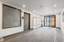 Building entrance featuring commercial-style glass doors, wall-mounted mailboxes, recessed lighting, and a textured area rug - 412 5005 165 Avenue Nw, Edmonton, AB  - Indoor Photo Showing Other Room 
