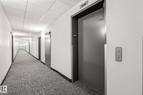 Hallway with patterned carpeting, recessed lighting, and white walls - 412 5005 165 Avenue Nw, Edmonton, AB - Indoor Photo Showing Other Room
