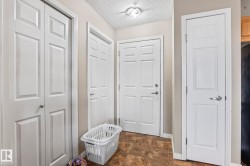 Entryway featuring paneled doors, textured ceiling, and a flush mount light fixture - 