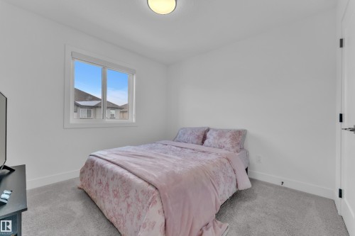 Room featuring light gray carpeting, a single window with white trim, and a flush-mount ceiling light - 9 Hunter Place, Spruce Grove, AB - Indoor Photo Showing Bedroom