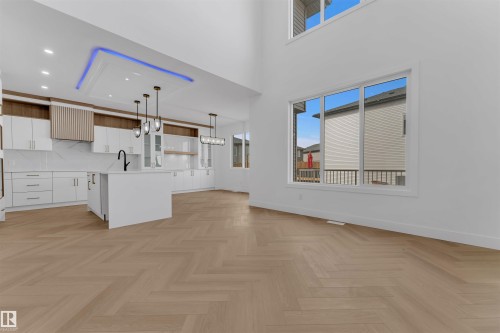 Open-concept living space featuring high ceilings and large windows - 12 Dalquist Bay, Leduc, AB - Indoor Photo Showing Kitchen
