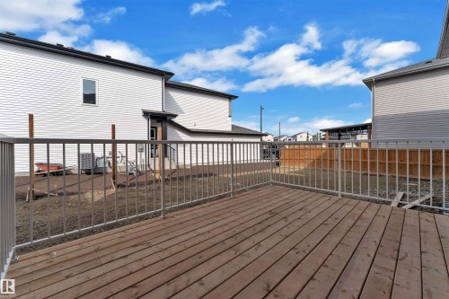 Wood deck with metal railing, offering outdoor living space - 12 Dalquist Bay, Leduc, AB - Outdoor With Deck Patio Veranda With Exterior