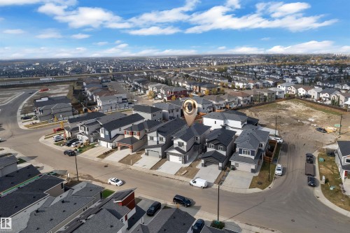 Aerial perspective showcasing a residential neighborhood with a mix of contemporary homes, paved streets, and undeveloped parcels - 12 Dalquist Bay, Leduc, AB - Outdoor With View