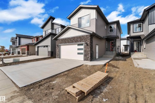 Modern two-story residence with a multi-textured facade featuring brick and siding - 12 Dalquist Bay, Leduc, AB - Outdoor With Facade