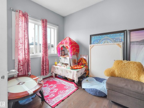 Room featuring light gray painted walls and dark wood-finish flooring - 5192 1B Ave Sw, Edmonton, AB - Indoor