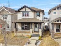 Contemporary two-story residence featuring light-colored siding with dark trim accents - 5192 1B Ave Sw, Edmonton, AB  - Outdoor With Deck Patio Veranda With Facade 
