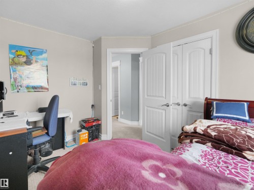 Interior room with light neutral walls and carpeted flooring - 5192 1B Ave Sw, Edmonton, AB - Indoor Photo Showing Bedroom