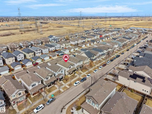 Aerial perspective showcasing a residential street with multiple single-family homes - 5192 1B Ave Sw, Edmonton, AB - Outdoor With View