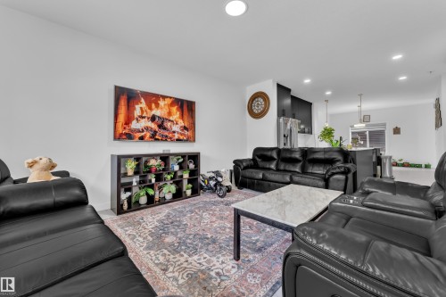 Open-concept living space featuring recessed lighting, light-toned walls, and wood-finish flooring - 1645 Plum Circle Circle, Edmonton, AB - Indoor Photo Showing Living Room
