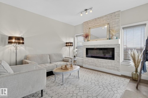 94 Tribute Common, Spruce Grove, AB - Indoor Photo Showing Living Room With Fireplace