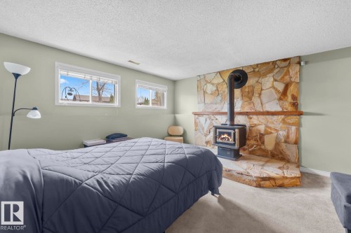 4104 43 Street, Bonnyville Town, AB - Indoor Photo Showing Bedroom With Fireplace